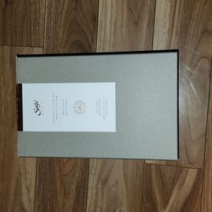 A brand new Saje Diffuser and a set of essential oils in their original boxes.